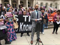 Darius Charney speaks in front of City Hall 